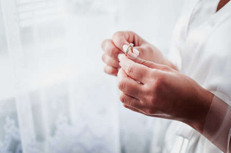 Bride hold gold diamond wedding ring in the hand