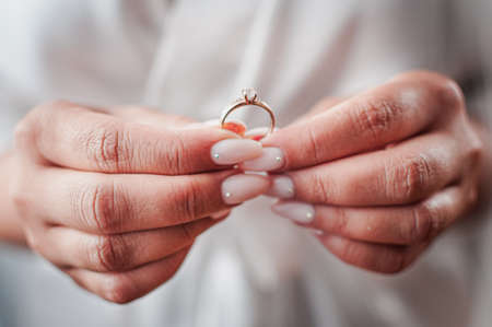 Bride hold gold diamond wedding ring in the handの写真素材