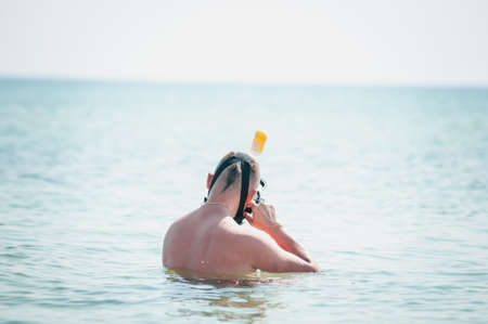 Man swimming with snorkeling mask in the oceanの写真素材