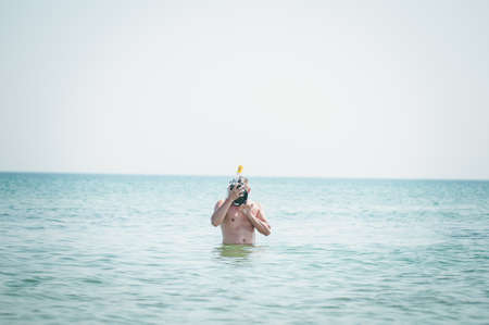 Man in swiming mask going on waterの写真素材
