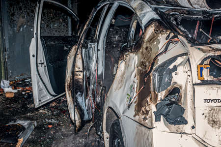 Ternopil, Ukraine - 18.02.2014 - Damaged police car near the burning police departmentのeditorial素材