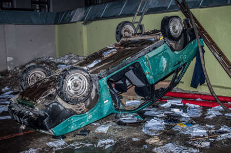 Ternopil, Ukraine - 18.02.2014 - Inverted and damaged car near the burning police departmentのeditorial素材