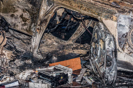 Ternopil, Ukraine - 18.02.2014 - An overturned and burnt car near the burning police station
