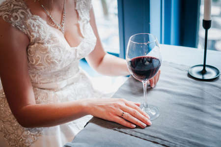 Glass with wred wine in the girls handの写真素材
