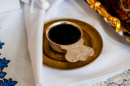 church silver chalice with wine on the silver plate