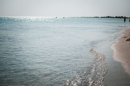 Sand beach sea coast and people on the background