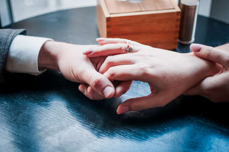 Man and woman holding hands together