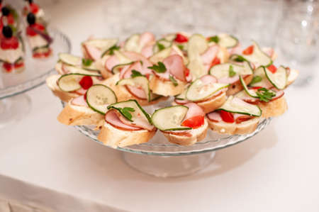 canapes with ham, fresh cucumber and cherryの写真素材