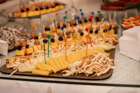 Wedding buffet. Slicing different varieties of cheeseの写真素材