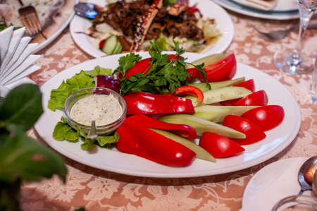 Slicing vegetables on a white plateの写真素材