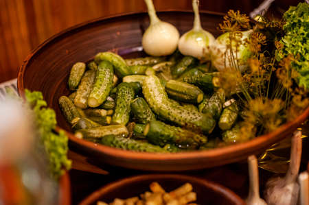 Marinated cucumbers, garlic and dill on a plateの写真素材