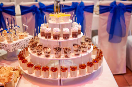 Sweet cakes in cups at a wedding buffet. Candy bar cateringの写真素材