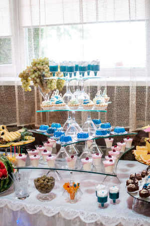 Candy bar with sweet cakes at a weddingの写真素材