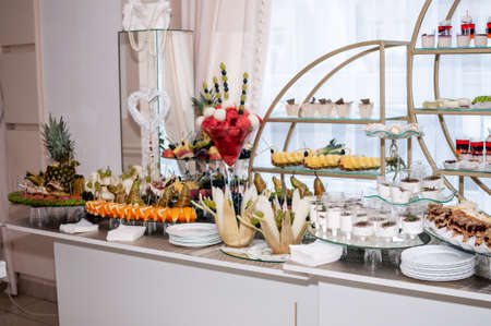 Sweet cakes in cups at a wedding buffet. Candy bar cateringの写真素材