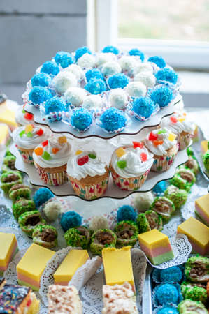 Sweet cakes at a wedding buffet. Catering