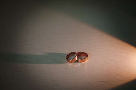 Gold wedding rings on the table. Wedding accessories