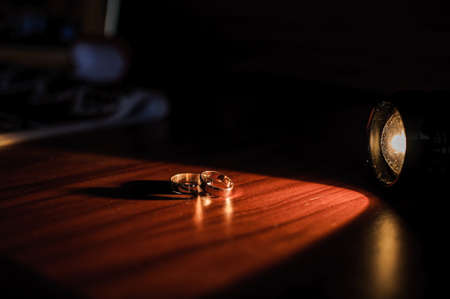 Wedding gold rings on brown backgroundの写真素材