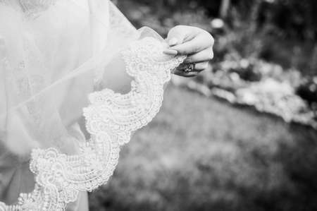 white veil in the hands of the brideの写真素材