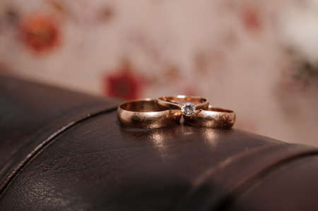 Wedding gold rings on brown background