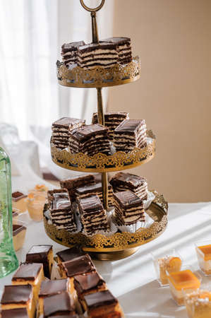 Sweet cakes at a wedding banquet. Catering, sweet festive buffet. Candy barの写真素材