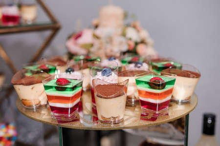 Sweet cakes at a wedding banquet. Catering, sweet festive buffet. Candy barの写真素材