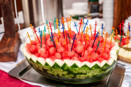Fruit slicing at a wedding banquet. Watermelon, grapes, strawberry, orange, plum, pear, dinha, peach, kiwi, pineapple, persimmon, appleの写真素材