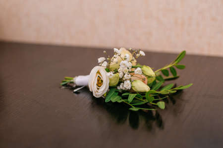 Groom boutonniere on brown background