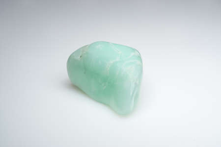 Natural chrysoprase stone on a white backgroundの写真素材