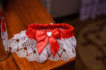 Red bride garter on brown backgroundの写真素材