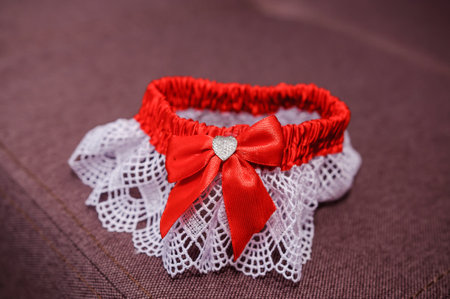 Red bride garter on brown backgroundの写真素材