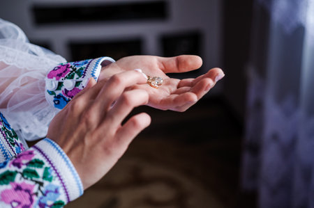Earrings in the hands of the bride. Bridal wedding accessoriesの写真素材