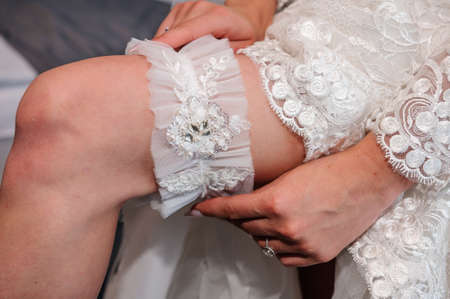 Garter of the bride on the leg of the brideの写真素材