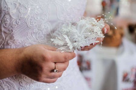 Boutonniere in the hands of the brideの写真素材