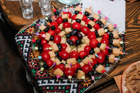 Canapes with cherry tomatoes and mozzarella on skewersの写真素材