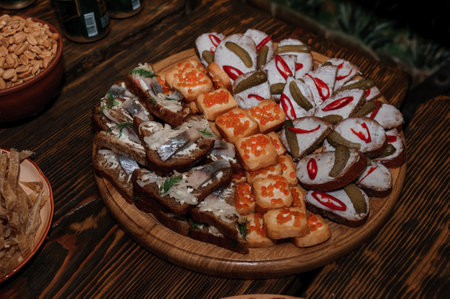 Canapes with herring, canapes with red caviar, canapes with cucumber and pepperの写真素材