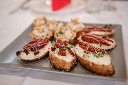 Canapes with sun-dried tomatoes and microgreen