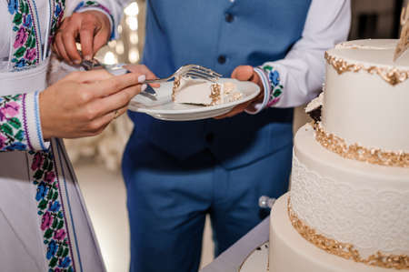 Newlyweds cut the wedding cake. The bride and groom at the wedding cut a wedding cakeの写真素材