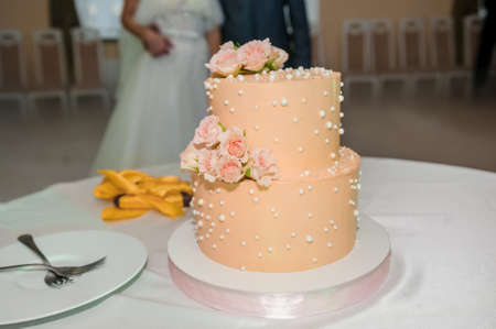 Beautiful wedding cake decorated with flowers, cake close up and blur backgroundの写真素材