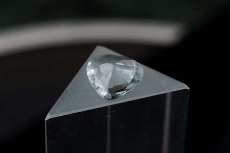 Natural blue aquamarine on a standの写真素材