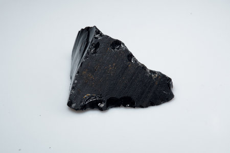 Natural black obsidian stone on backgroundの写真素材
