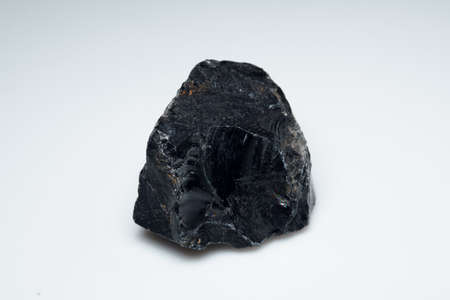 Natural black obsidian stone on background