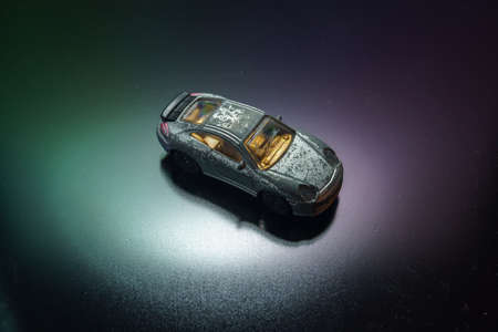 old retro scratched model toy sports car on the background