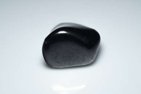 natural black shungite cabochon on backgroundの写真素材