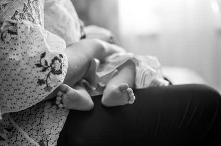 closeup feets of the child on parentの写真素材
