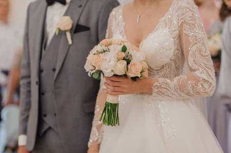 Bouquet of flowers in the hand of the bride