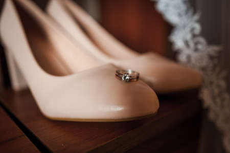 Brides shoes, gold rings. Morning of the bride. Wedding detailsの写真素材