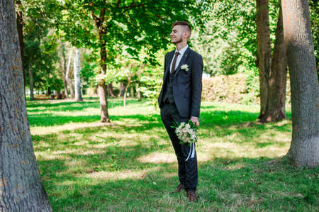Portrait of the groom on a green backgroundの写真素材