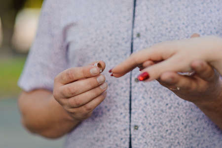 An offer of marriage. Golden ring on a womans hand