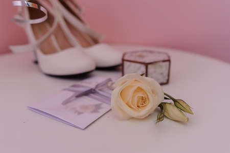 Brides accessories. Gold wedding rings, boutonniere of the groom, for the bride, wedding invitationの写真素材