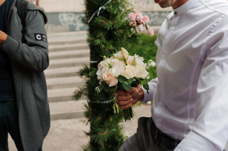 Wedding bouquet in the hands of the groomの写真素材